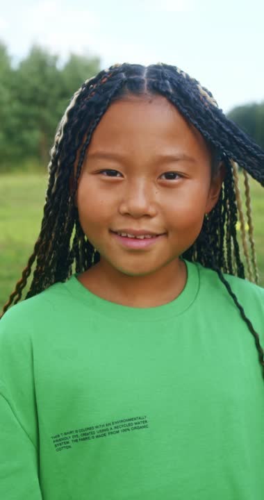 A child smiling outdoors